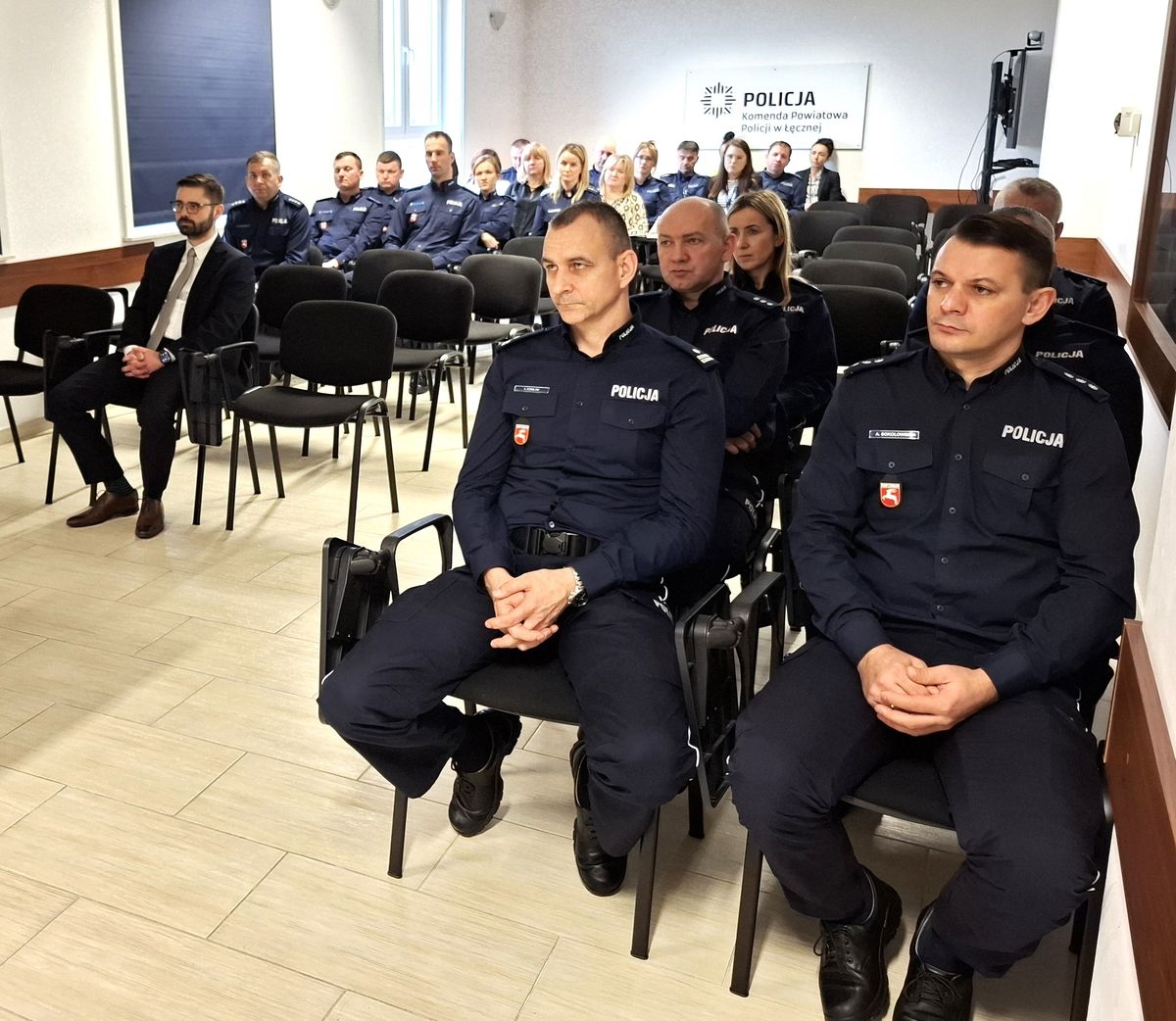 policjanci i pracownicy cywilni na sali odpraw