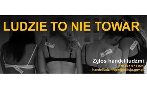 Cztery kobiety w bieliźnie z etykietkami przypiętymi na plecach. U góry żółty napis: Ludzie to nie towar. Na dole biały napis: Zgłoś handel ludźmi i na żólto numer telefonu: +48 664 974 934 i adres e-mail: handelludzmibsk@policja.gov.pl