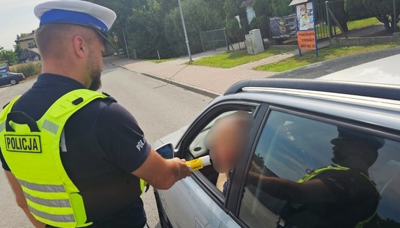 policjant kontroluje stan trzeźwości kierującego