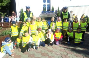 policjanci z przedszkolakami przy radiowozie