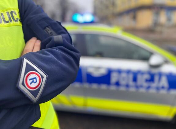 policjant na tle radiowozu