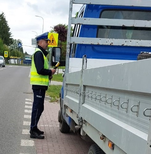 policjant sprawdza stan trzeźwości kierujacego