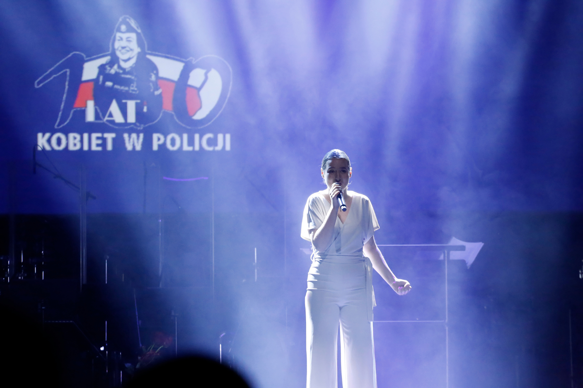 Wokalistka Emilia Marzec śpiewa piosenkę z okazji upamiętnienia setnej rocznicy powołania Policji Państwowej.
